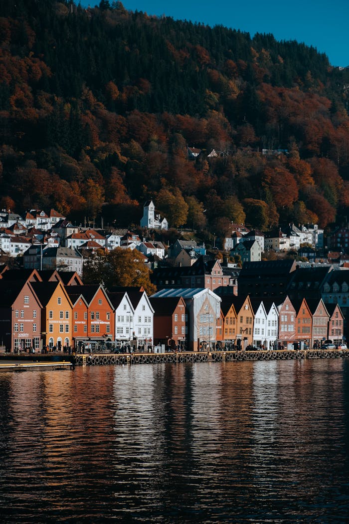 portfolio-02 Colorful houses reflect on the fjord in Bergen, Norway, showcasing autumn's beauty.