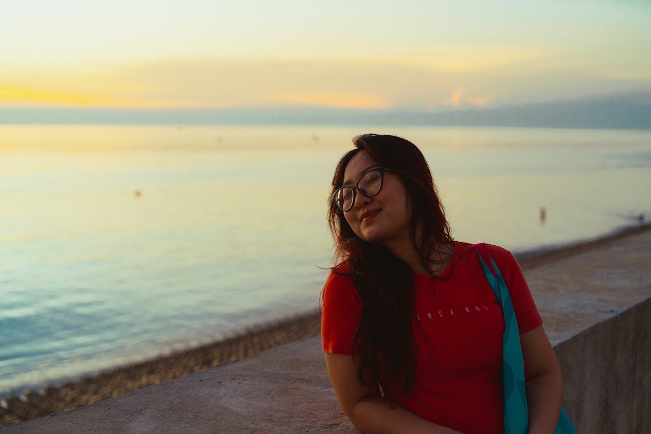 A serene moment by the sea in Bình Thuận, Vietnam, with a woman enjoying the sunset.