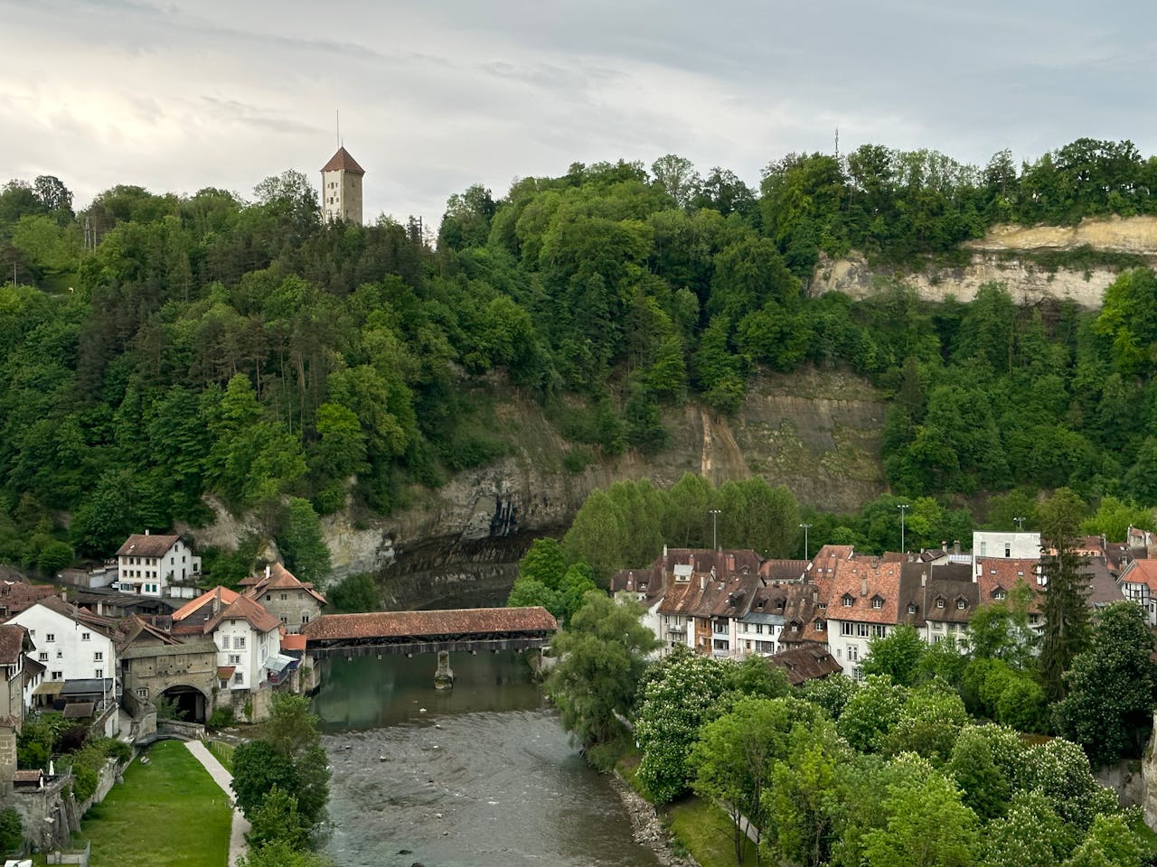 Explore the medieval charm of Fribourg, Switzerland, overlooking the scenic Saane River and historic buildings.