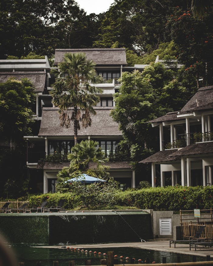 Beautiful modern resort buildings surrounded by lush tropical greenery, offering a serene getaway.